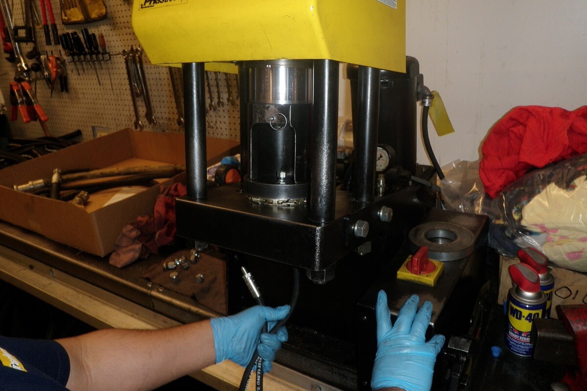 Hydraulic hose fitting crimper used during hose assembly work